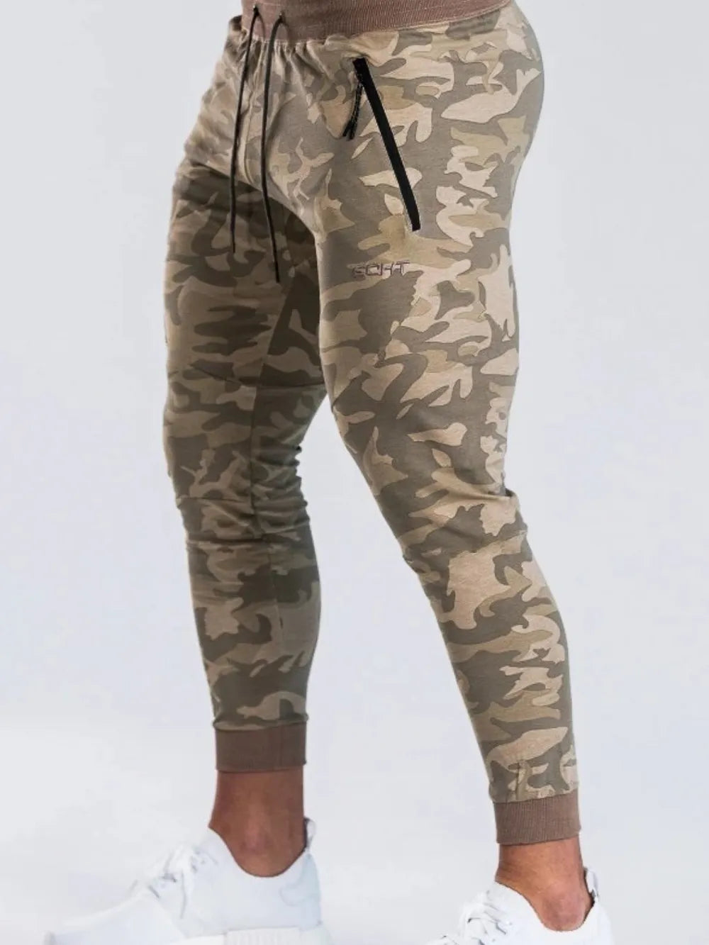 Menâ€™s camouflage drawstring active pants worn as casual athletic joggers
